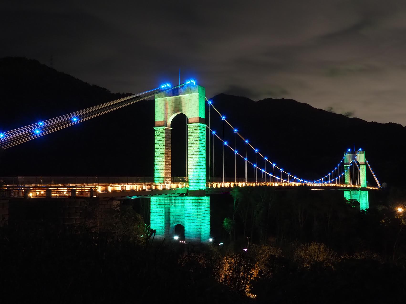 A stone bridge in Hadano-Tokagawa Park illuminated mito green
