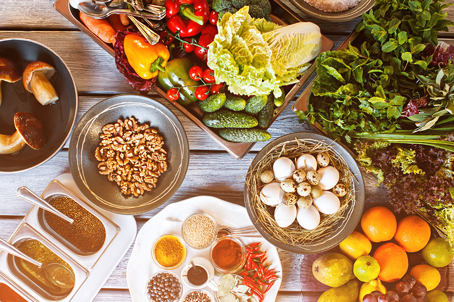 Nutritious food like vegetables, eggs, fruits and nuts are displayed from above